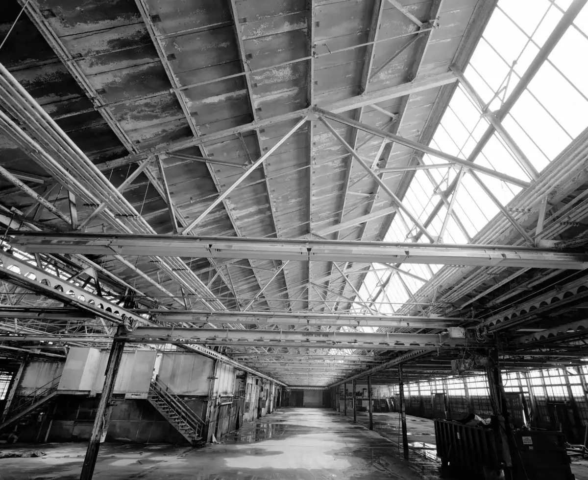Roof trusses and skylights inside a factory service building, from an archival building survey