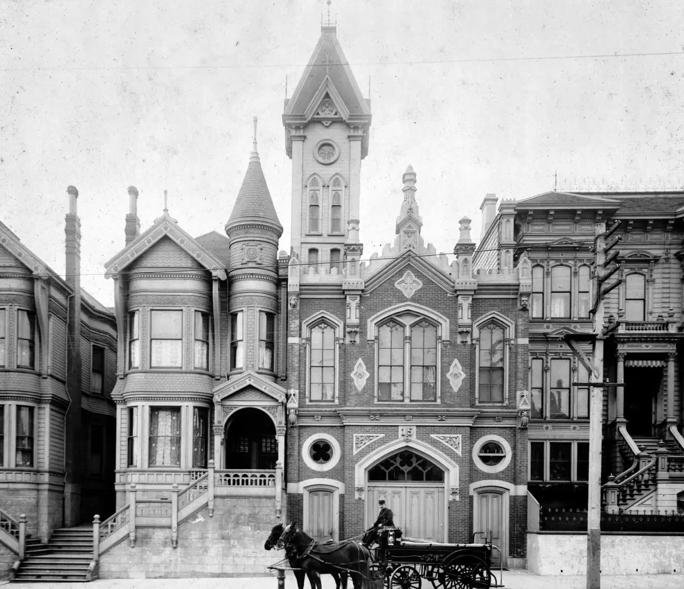 A Victorian firehouse with a horse-drawn engine outside, photographed in 1894 for the Historic American Buildings Survey