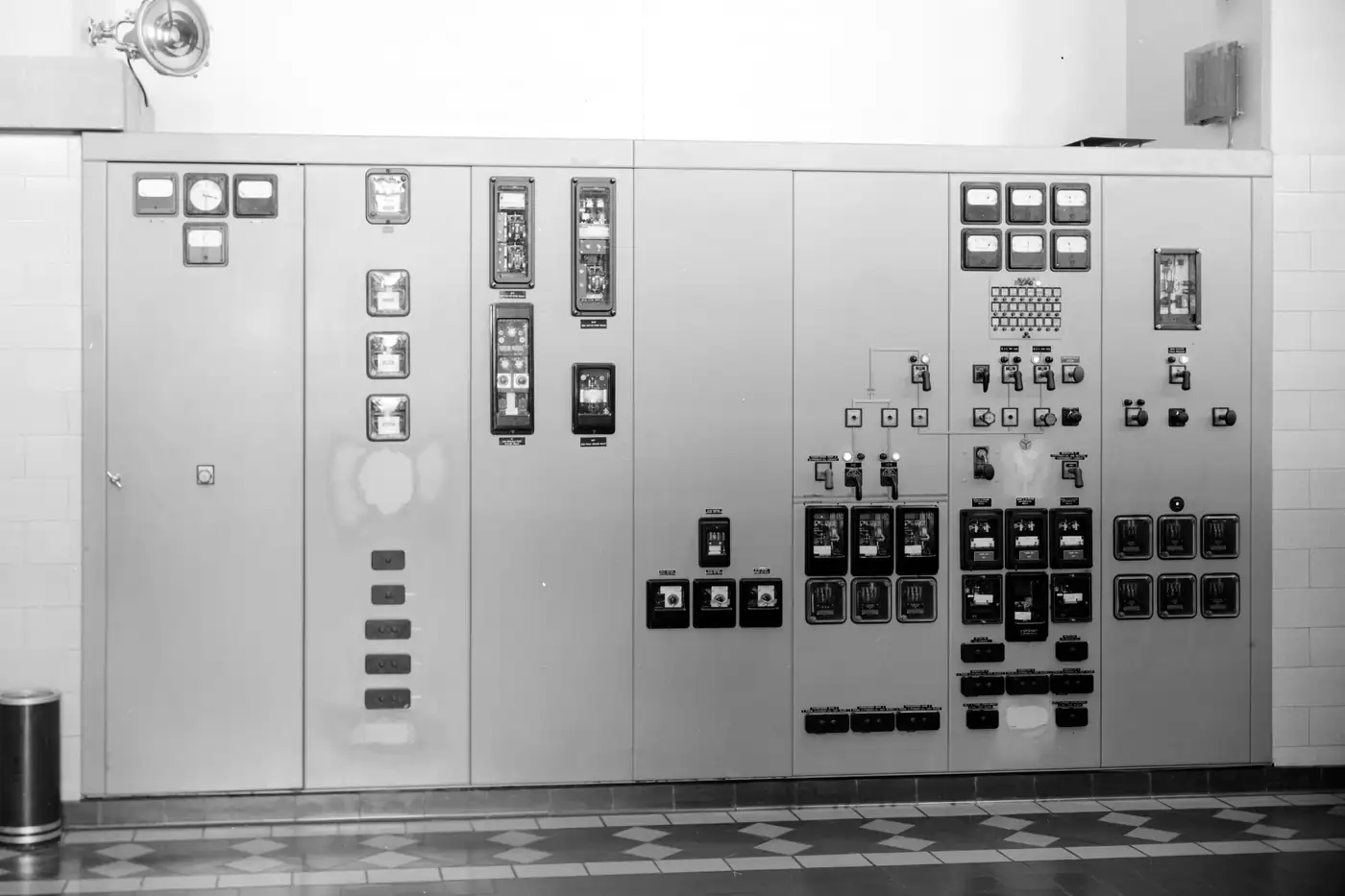 A generator control switchboard in a powerhouse, from an archival engineering survey